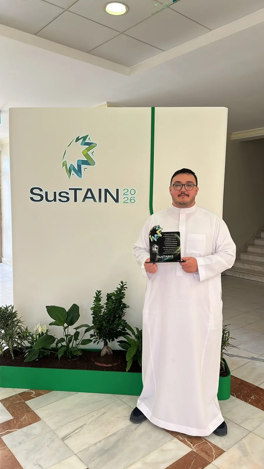 Salem holding the SusTAIN 2026 recognition plaque